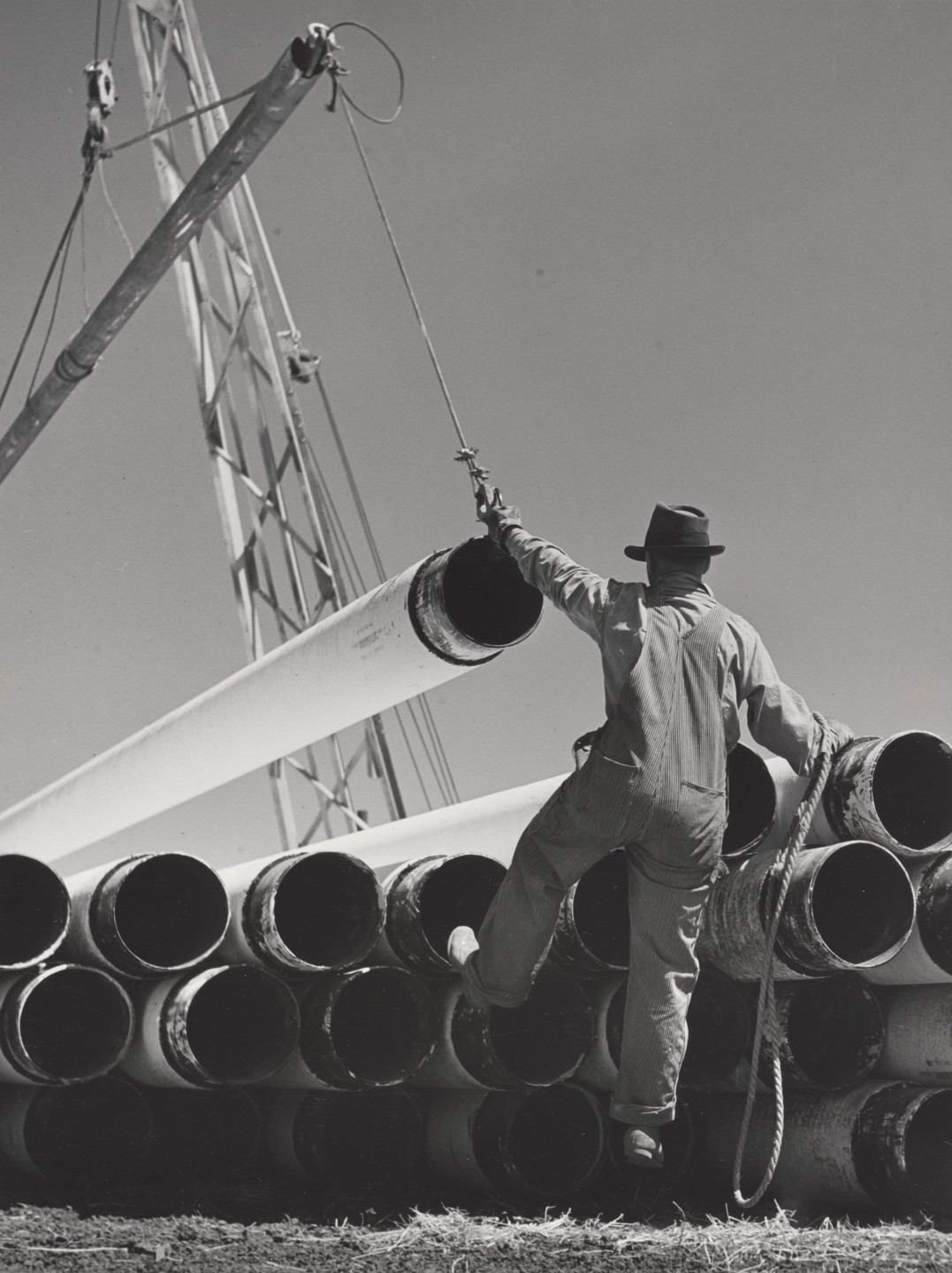 Robert Ingram. Stockpiling Coated Pipe. 1940