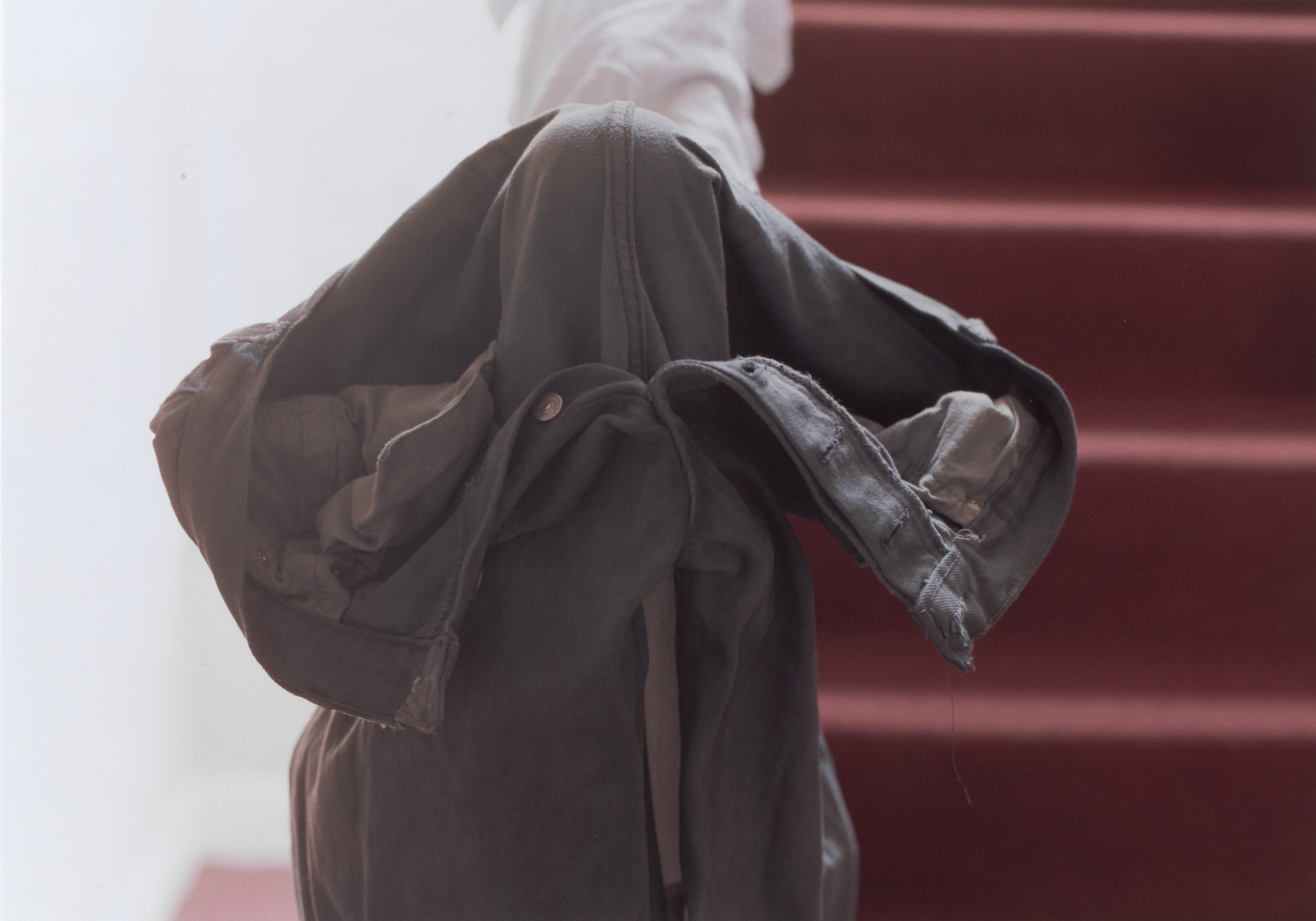Wolfgang Tillmans. grey jeans over stair post. 1991