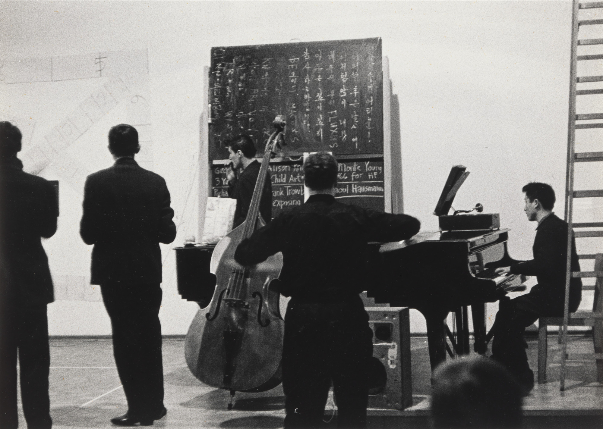 La Monte Young, Nam June Paik. Arabic Numeral (Any Integer) for Henry Flynt and other simultaneous performances, performed during Festum Fluxorum/Fluxus/Musik und Antimusik/Das Instrumentale Theater, Staatliche Kunstakademie, Düsseldorf, February 2-3, 1963