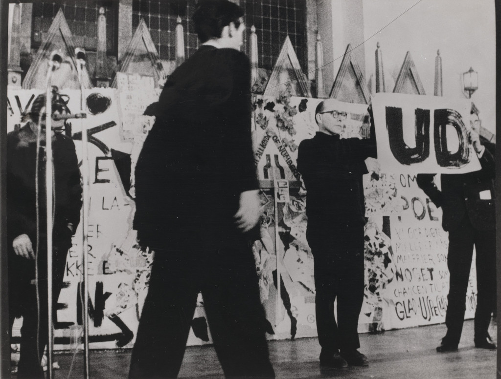 George Brecht's Word Event (1961), performed by Emmett Williams and George Maciunas during Fluxus/Musik og Anti-Musik/det Instrumentale Teater, Nikolai Kirke, Copenhagen, November 23, 1962 by Emmett Williams, George Maciunas, George Brecht