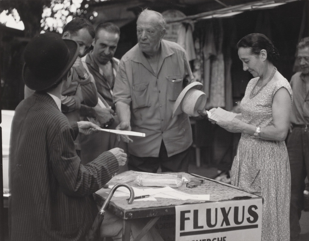 Signing certificates, performed during Fluxus Festival of Total Art and Comportment, Flea market, Nice, July 25, 1963