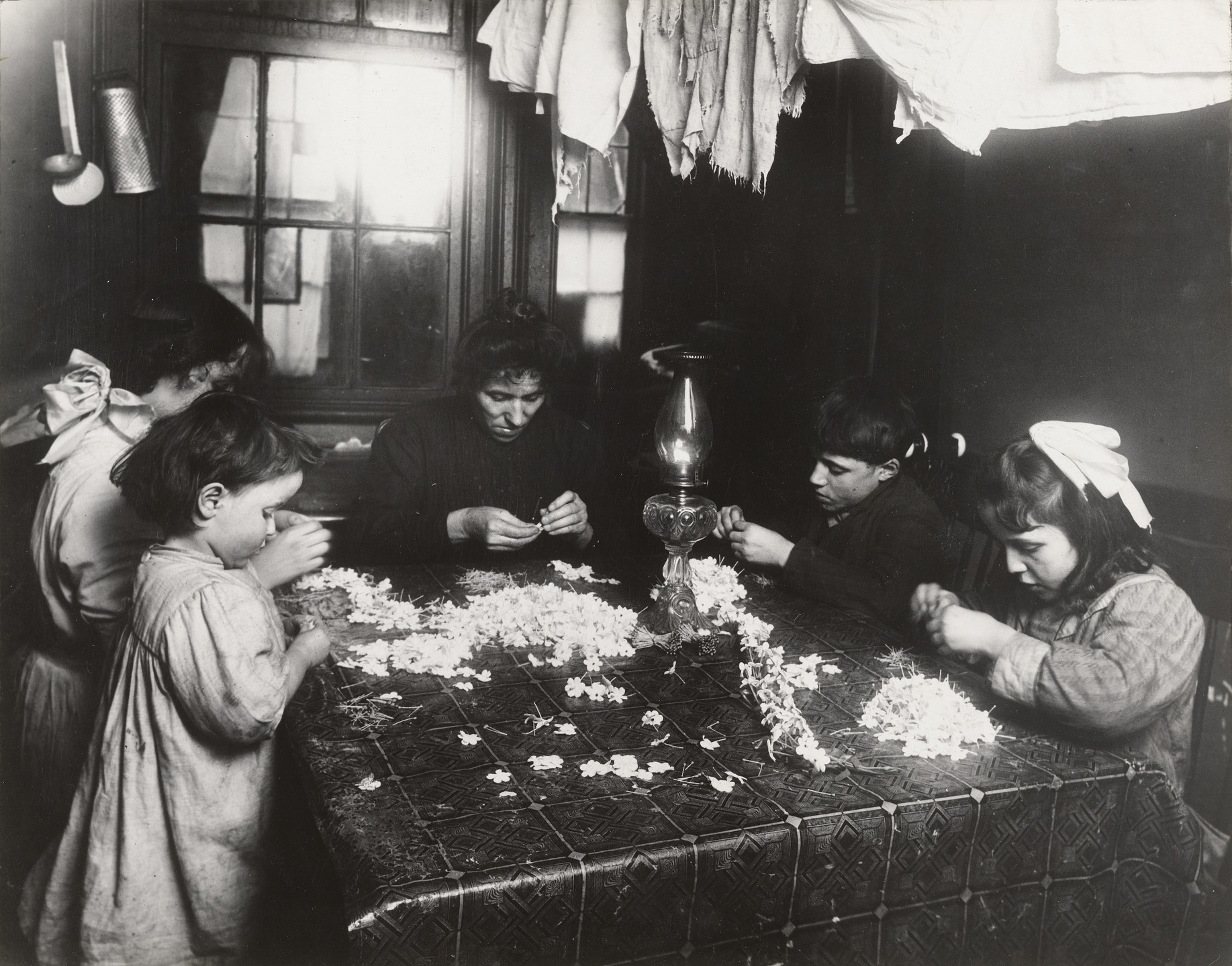 Lewis Wickes Hine. Making Flowers in a Slum Home. 1908