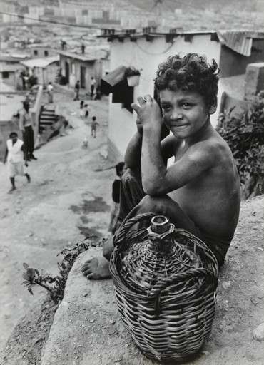 Boy on hillside overlooking Caracas, Venezuela