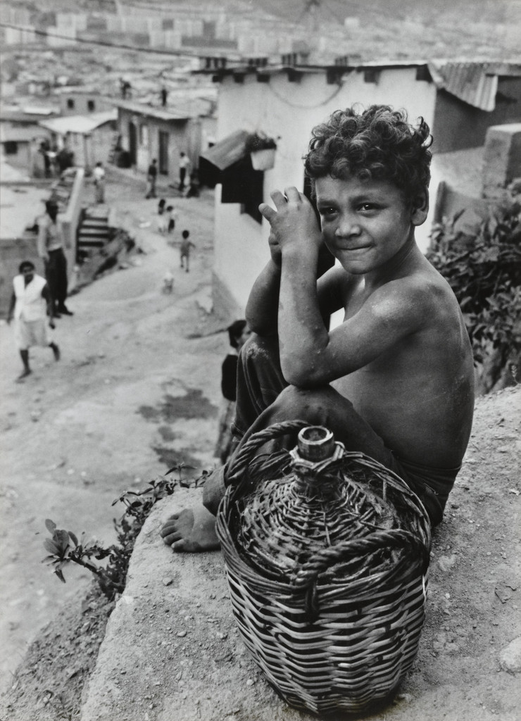 Boy on hillside overlooking Caracas, Venezuela