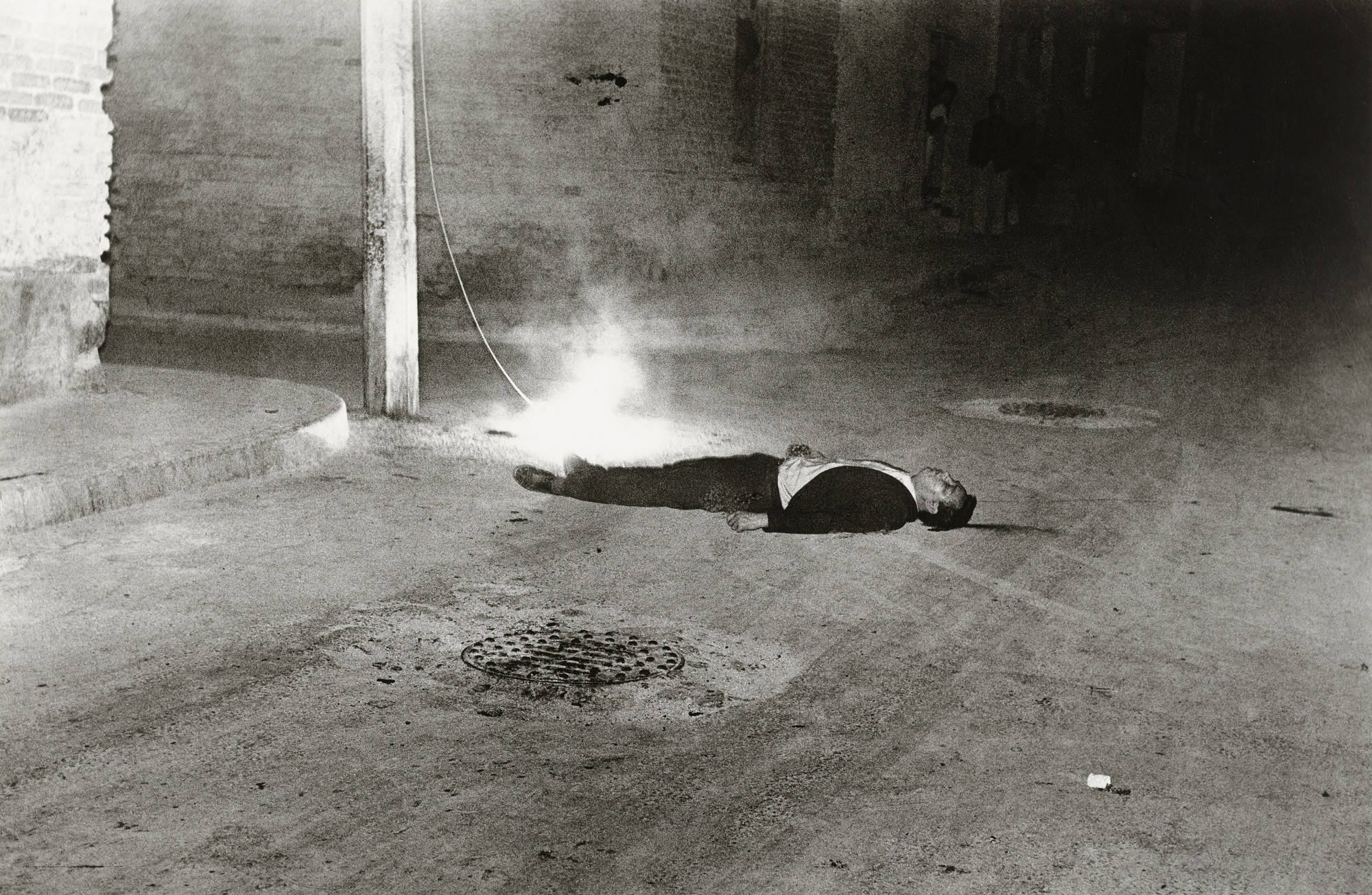 Enrique Metinides. A High Voltage Cable Snaps Loose and Hits a Man Walking Along Tacaba Street. Despite Being Badly Electrocuted, He Survived. 1958