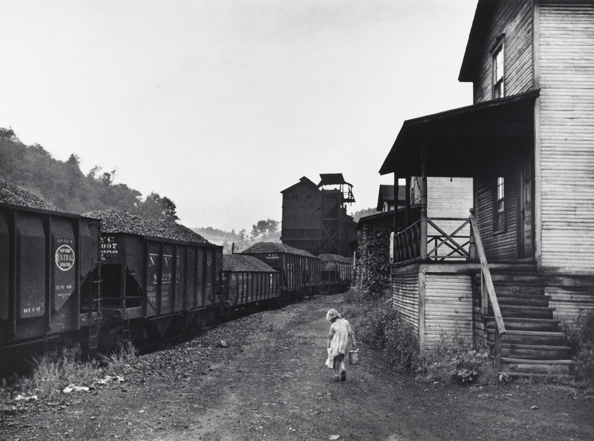 Marion Post Wolcott. Unemployed Coal Miner&#39;s Daughter Carrying Home Can of Kerosene; Company Housing, Pursglove, Scott&#39;s Run, West Virginia. 1938