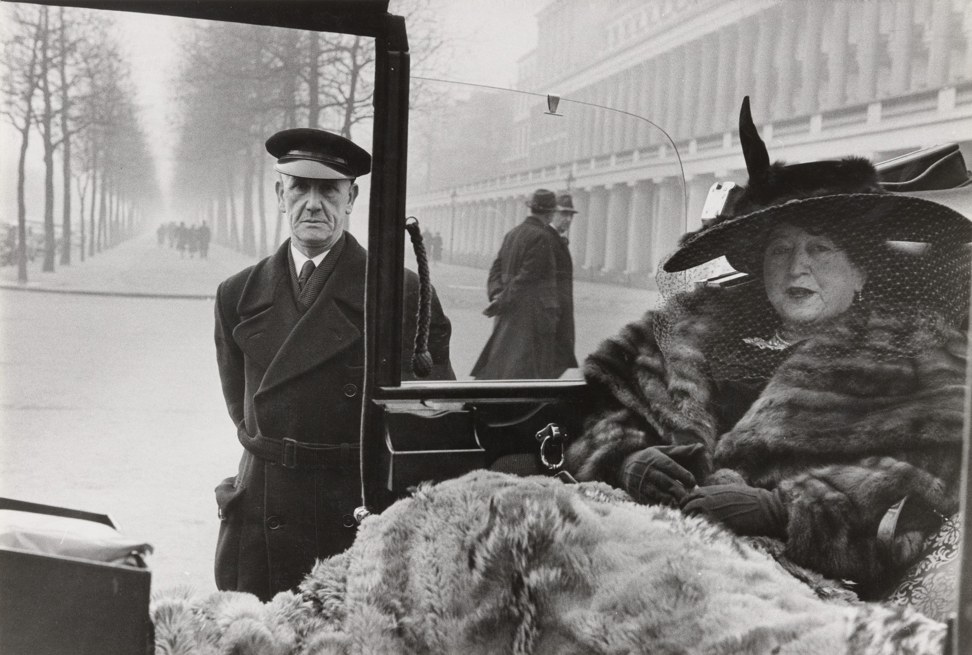 Inge Morath. Mrs. Eveleigh Nash with her Chauffeur at Buckingham Palace Mall. 1953