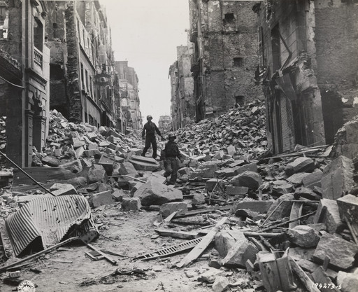 Untitled ("Two army first aid men search through the wreckage in the streets of Brest, France, for injured")