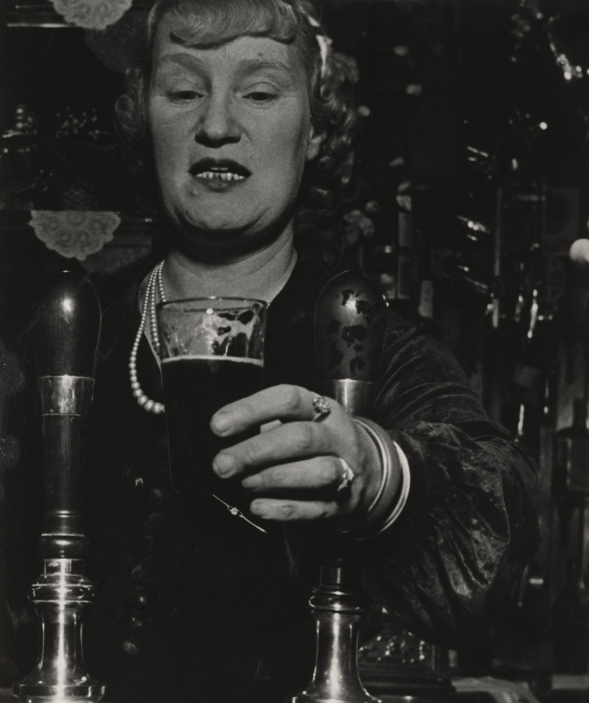 Bill Brandt. Barmaid at the Crooked Billet, Tower Hill. 1939