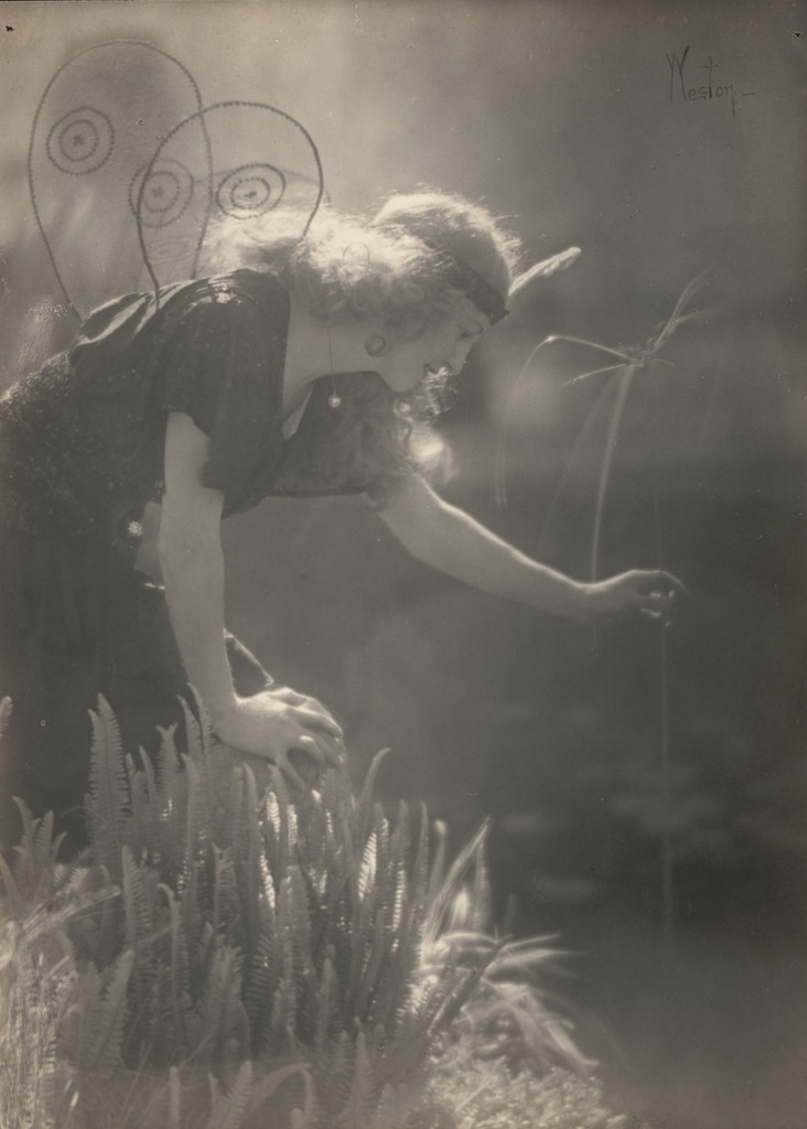 Violet Romer. (reaching for tall reed, wearing fairy costume)
