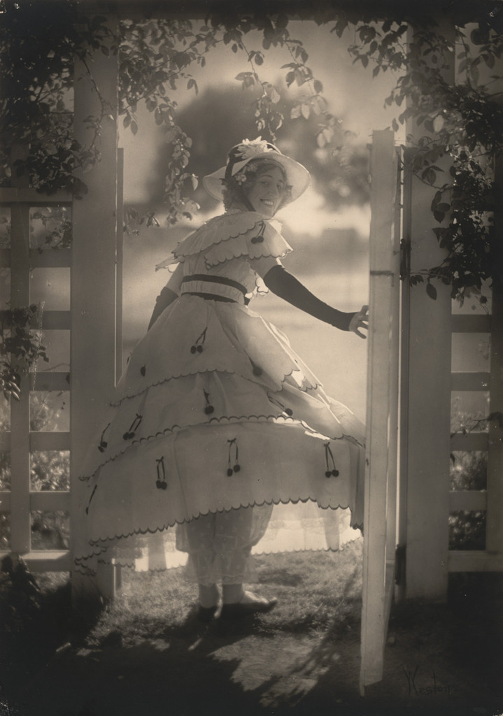 Violet Romer. (in hoop skirt by white gate)