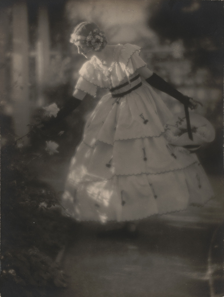 Violet Romer. (in hoop skirt admiring rose)