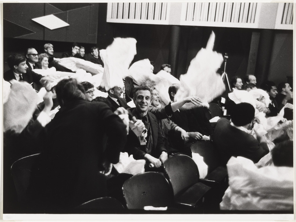 Audience members participating in Paper Piece (1960), performed during Fluxus Festival/Theatre Compositions/Street Compositions/Exhibits/Electronic Music, Hypokriterion Theater, Amsterdam, June 23, 1963