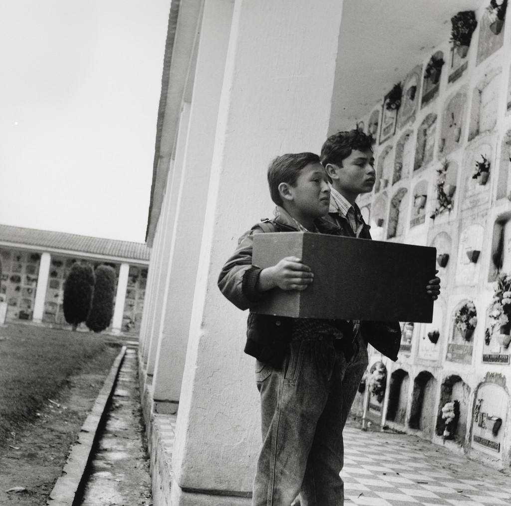 Two boys with a box of their grandmother's bones, Bogota, Colombia