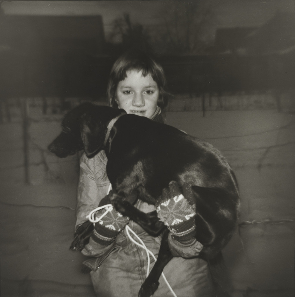 Shy Girl Holding her Black Dog