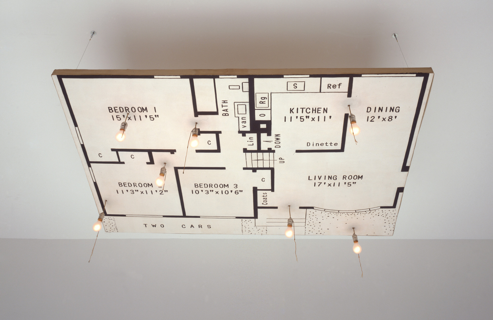 The image depicts a black and white floor plan of a house with rooms labeled including bedrooms, kitchen, bathroom, and living room. Several light bulbs hang down from different points on the floor plan. This is an AI generated description. To give feedback, email ai@moma.org.