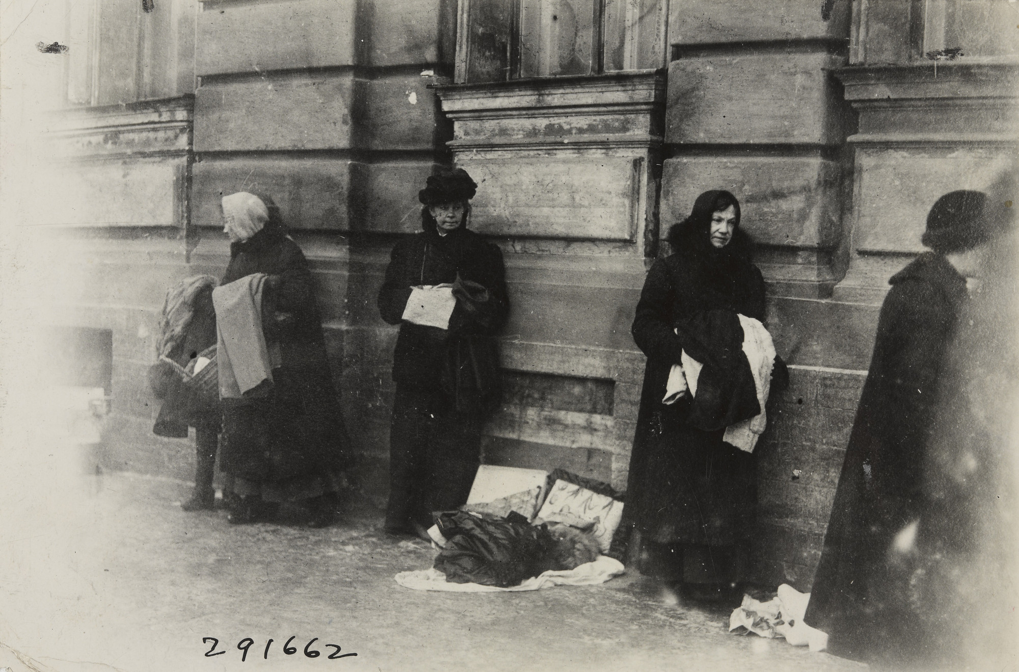 Underwood and Underwood. Women Selling the Remnants of Clothing Possessed by Themselves and their Family to Keep them from Starving