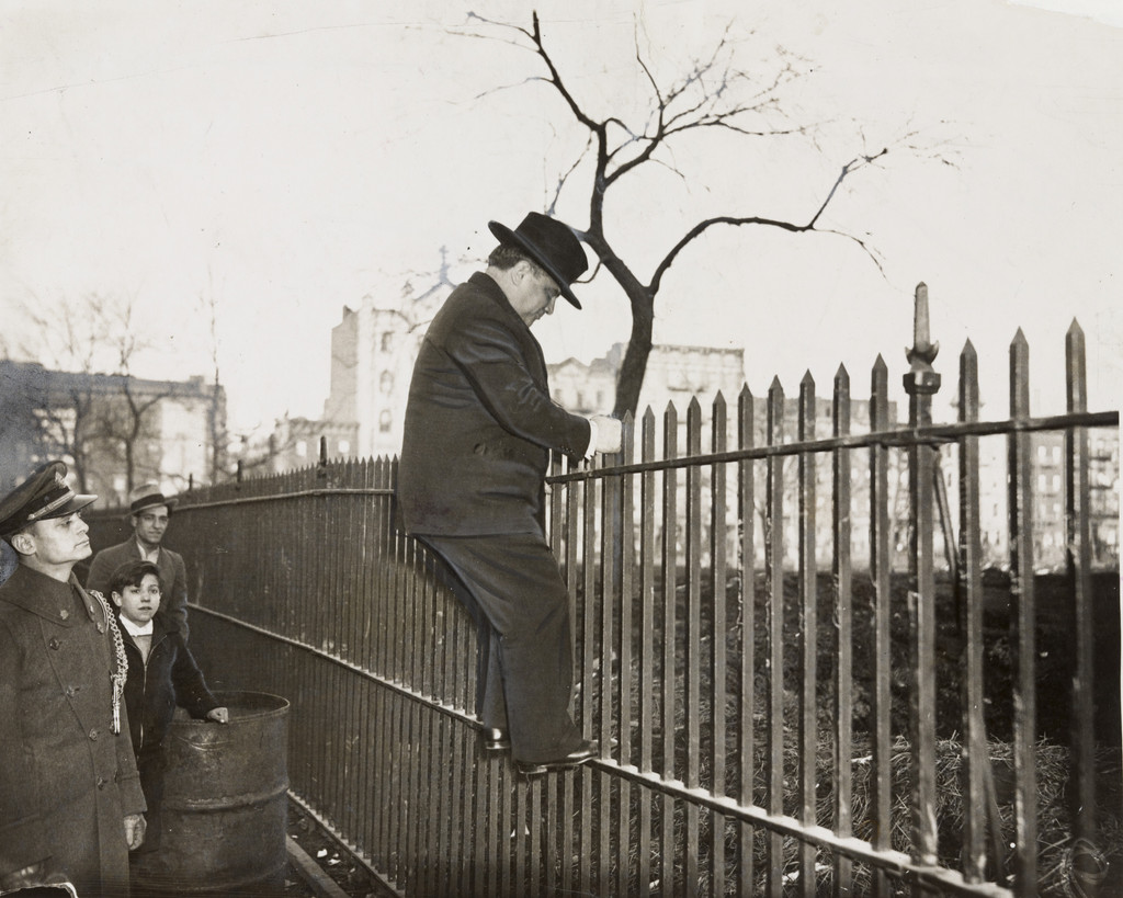 "Mayor La Guardia Climbs a Fence"