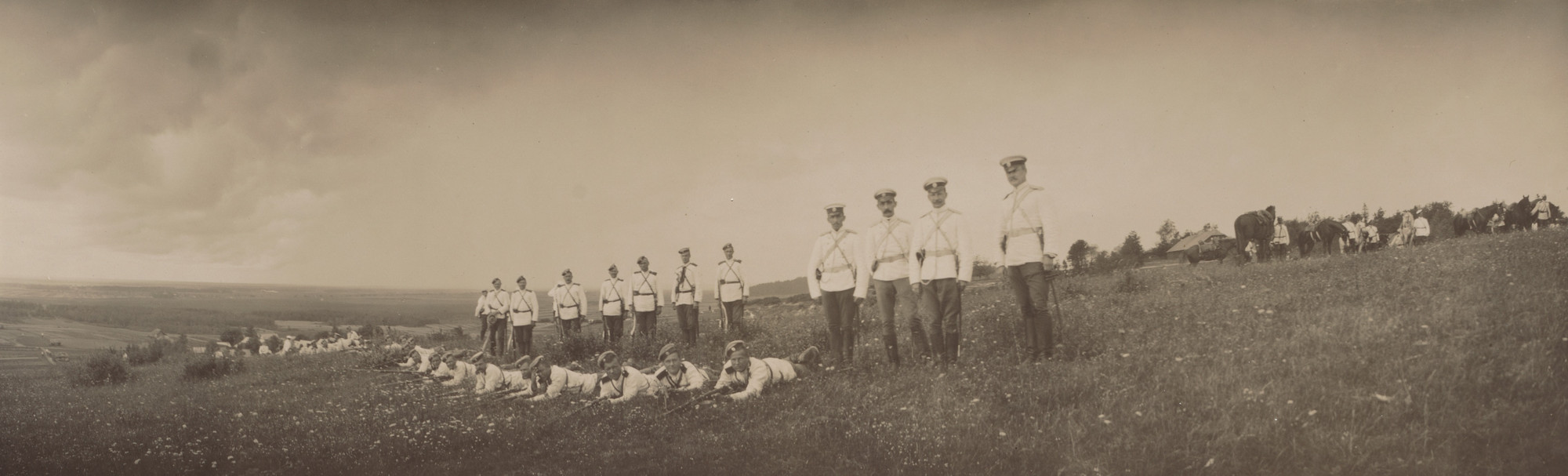 Unidentified photographer. Men Standing and Lying on Grass with Rifles, Peterhof