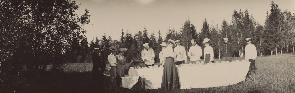 Grand Dukes Alexander Mikhailovich and Michael Alexandrovich, and Grand Duchess Xenia Alexandrovna, with Others, Standing Around a Table, Gatchino,