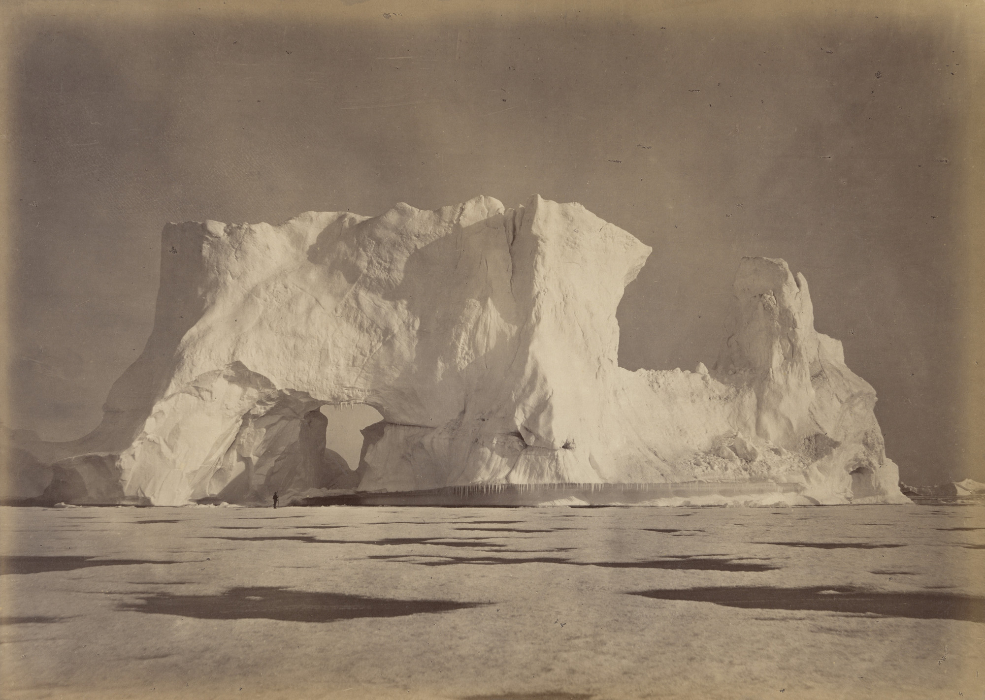 George P. Critcherson, John L. Dunmore, William Bradford. "Castle Berg in Melville Bay over two hundred feet high. The Figure, which is some seventy-five feet from the Base, gives an object to compare with the Berg. The Ice in the foreground is about eighteen inches in thickness.". 1869