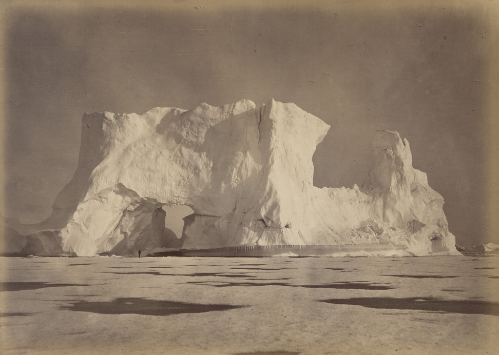 "Castle Berg in Melville Bay over two hundred feet high. The Figure, which is some seventy-five feet from the Base, gives an object to compare with the Berg. The Ice in the foreground is about eighteen inches in thickness."