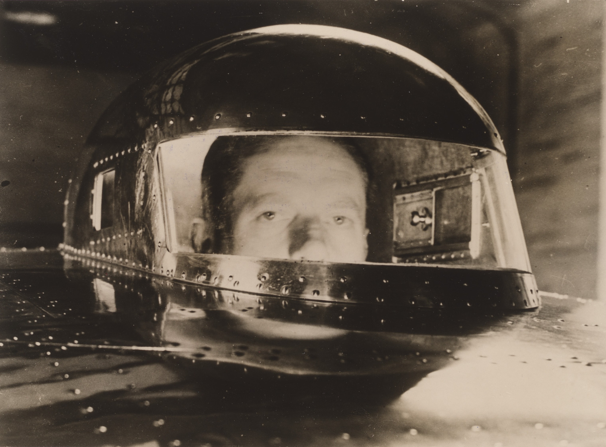 Unidentified photographer. Untitled (John Cobb in his 350 mile per hour car). 1938