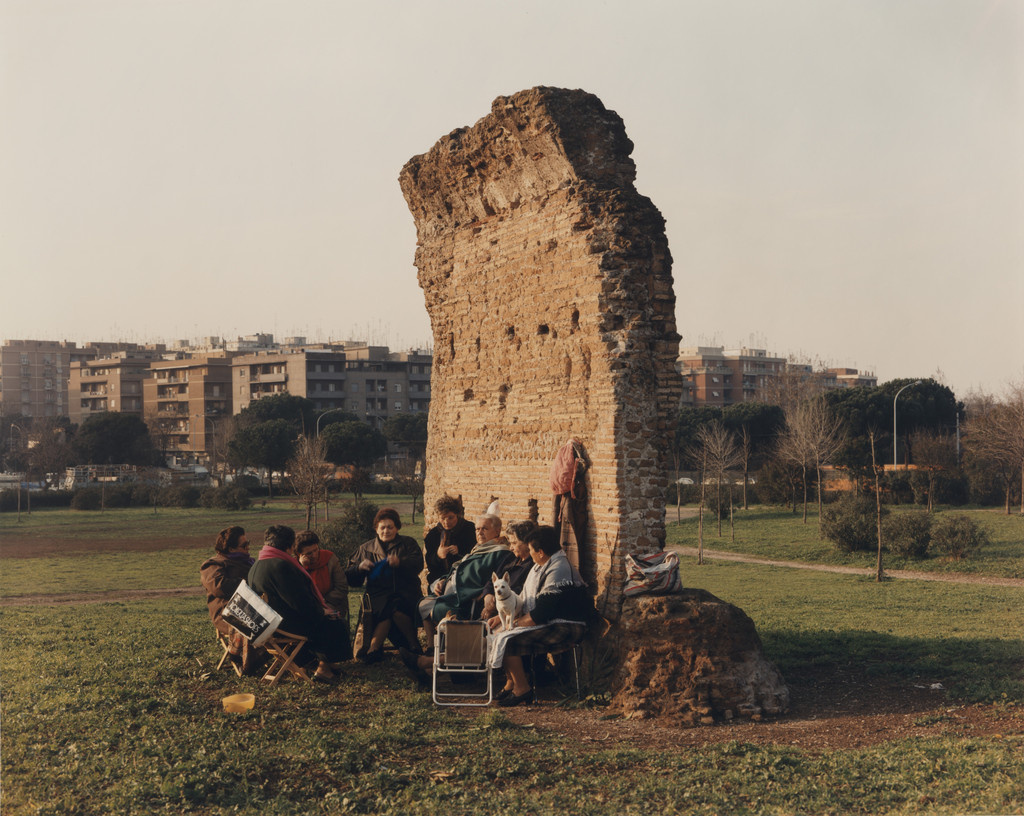 Women at their daily gathering beside an ancient Roman wall, Parco dei Gordiani, Rome