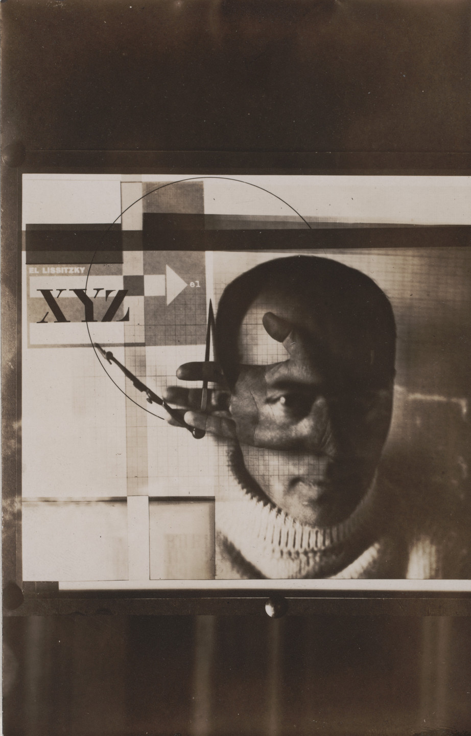 A sepia-toned image features a face with a hand holding a compass overlapping it, set against a geometric background with text and shapes in mainly black, white, and shades of brown. This is an AI generated description. To give feedback, email ai@moma.org.