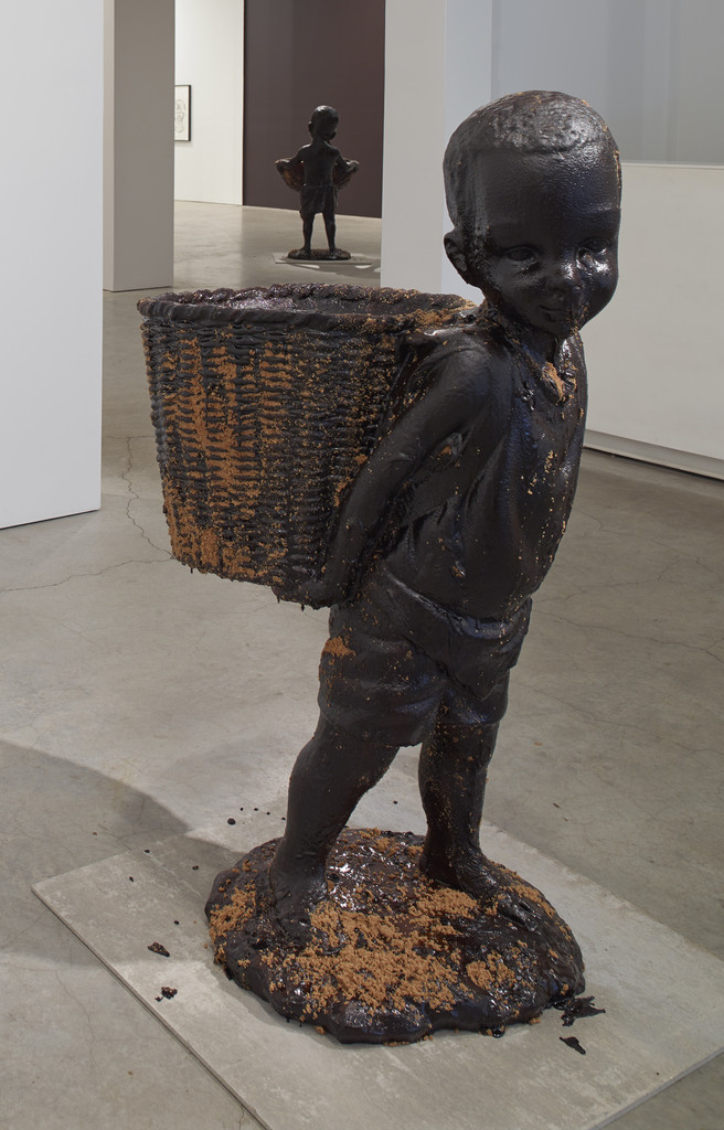 African Boy Attendant Curio with Molasses and Brown Sugar, from "The Marvelous Sugar Baby" Installation at the old Domino Sugar Factory Warehouse. (Rear Basket),