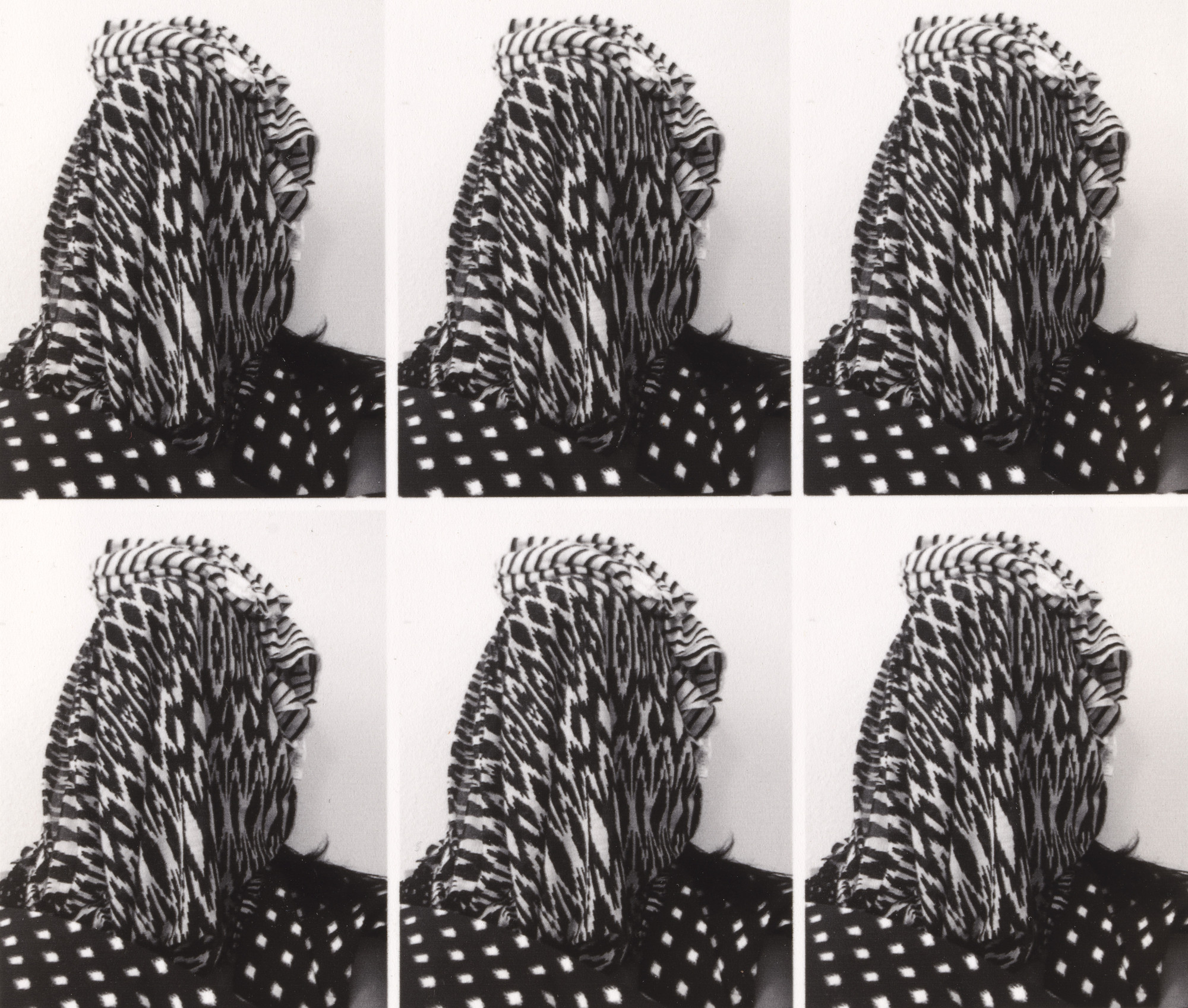 Applicant Photos (Migrants) #2 by Stephanie Syjuco photo from MOMA showing a 6 times repeating image of a headshot of a person completely covered in various patterned black and white fabrics