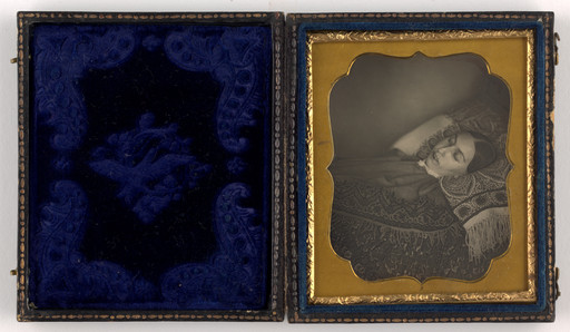 Unidentified photographer. Death Portrait of a Woman Lying On a Bed of Patterned Material. c. 1850