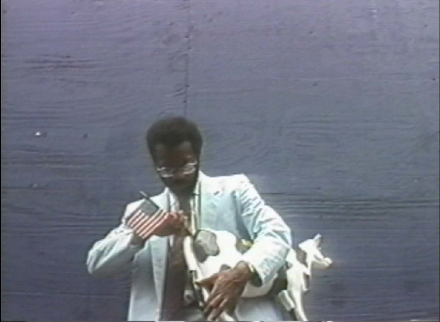 Pope.L. Black Domestic a.k.a. Cow Commercial. 1994