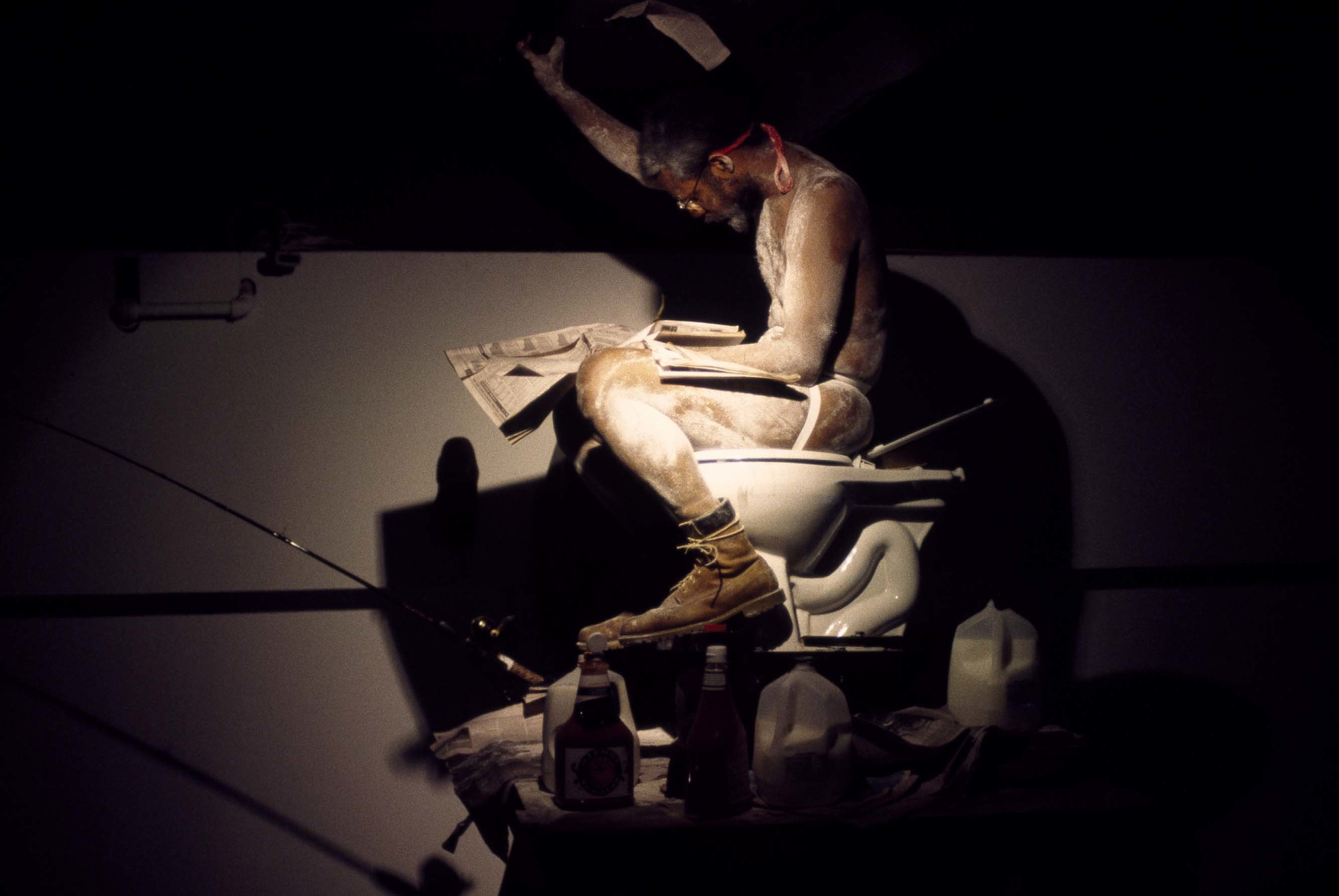 Pope.L. Eating the Wall Street Journal (3rd version). 2000