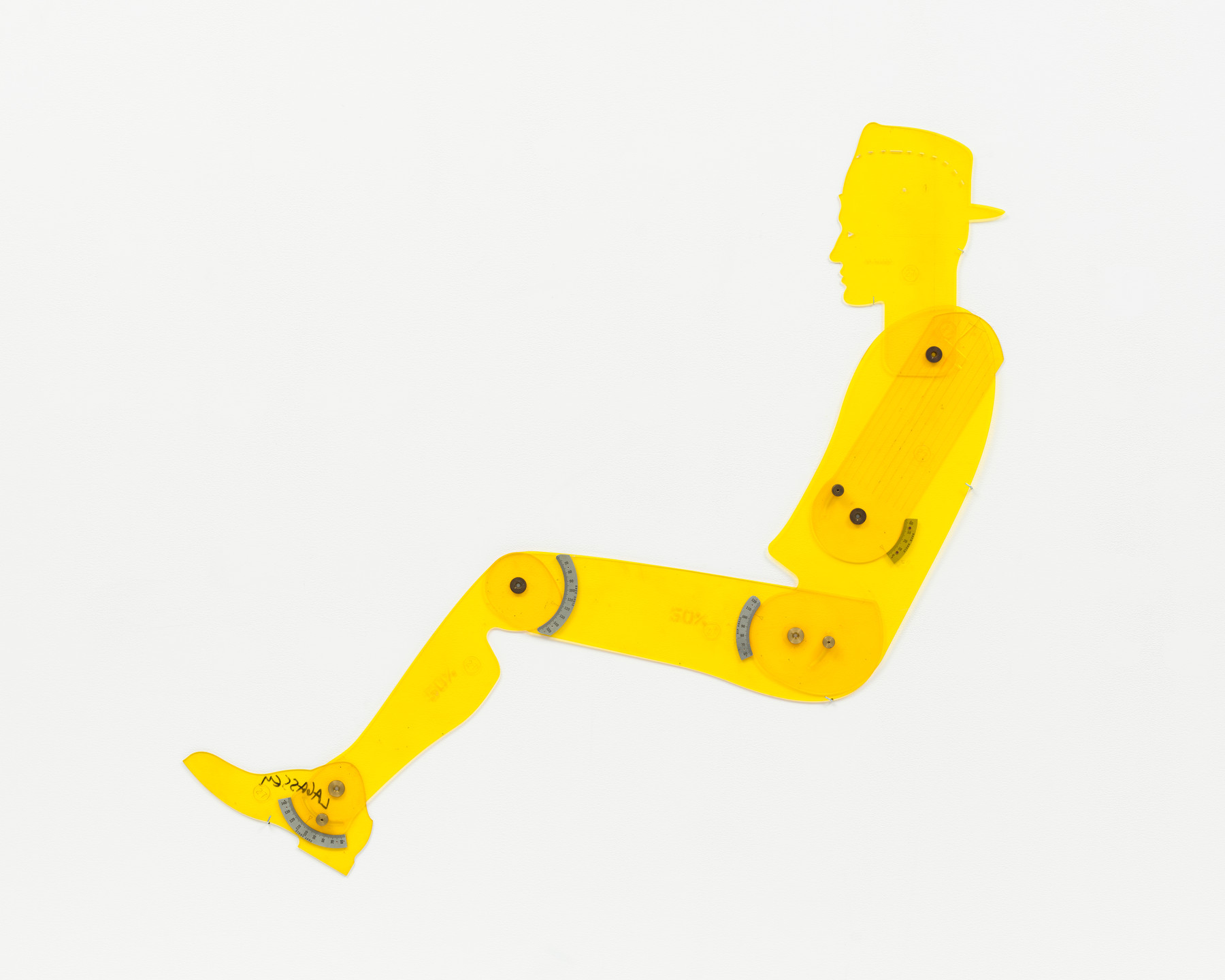 A yellow plastic cutout resembling a person sitting has movable joints held together with screws and protractors, visible against a plain white background. The figure wears a hat and shoes. This is an AI generated description. To give feedback, email ai@moma.org.