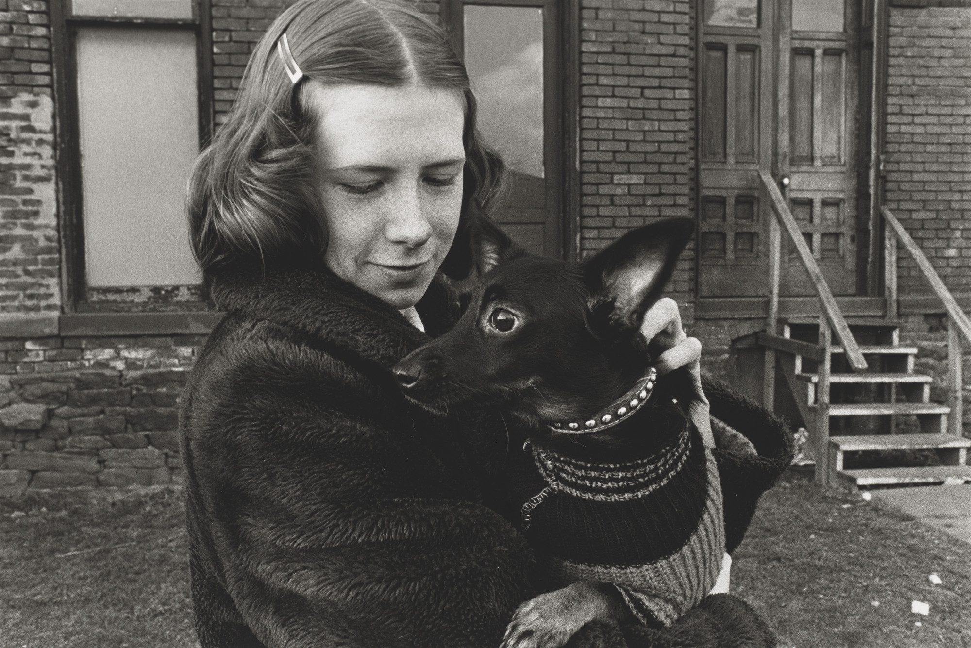 Mark Cohen. Girl Holding Small Black Dog