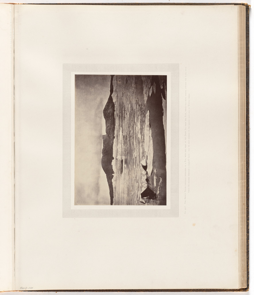 "The Devil's Thumb partially enveloped in a fog"
