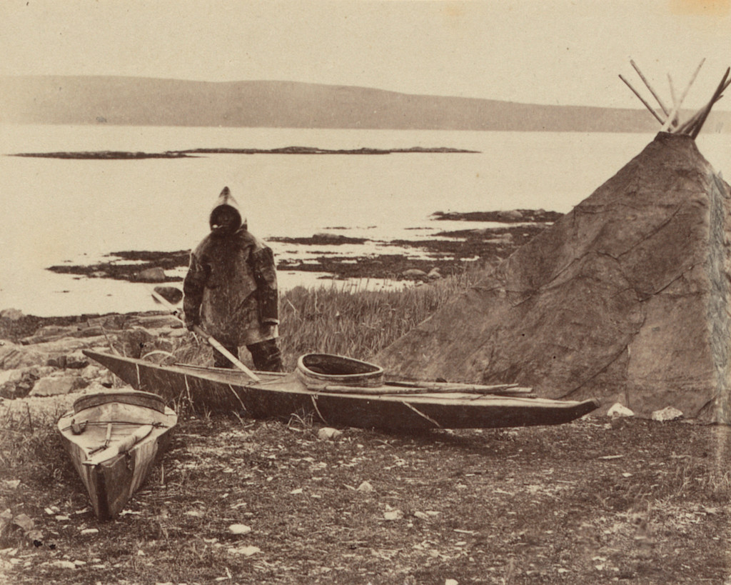 “An Esquimaux getting ready for a seal hunt, his toupek, or skin tent on the right”