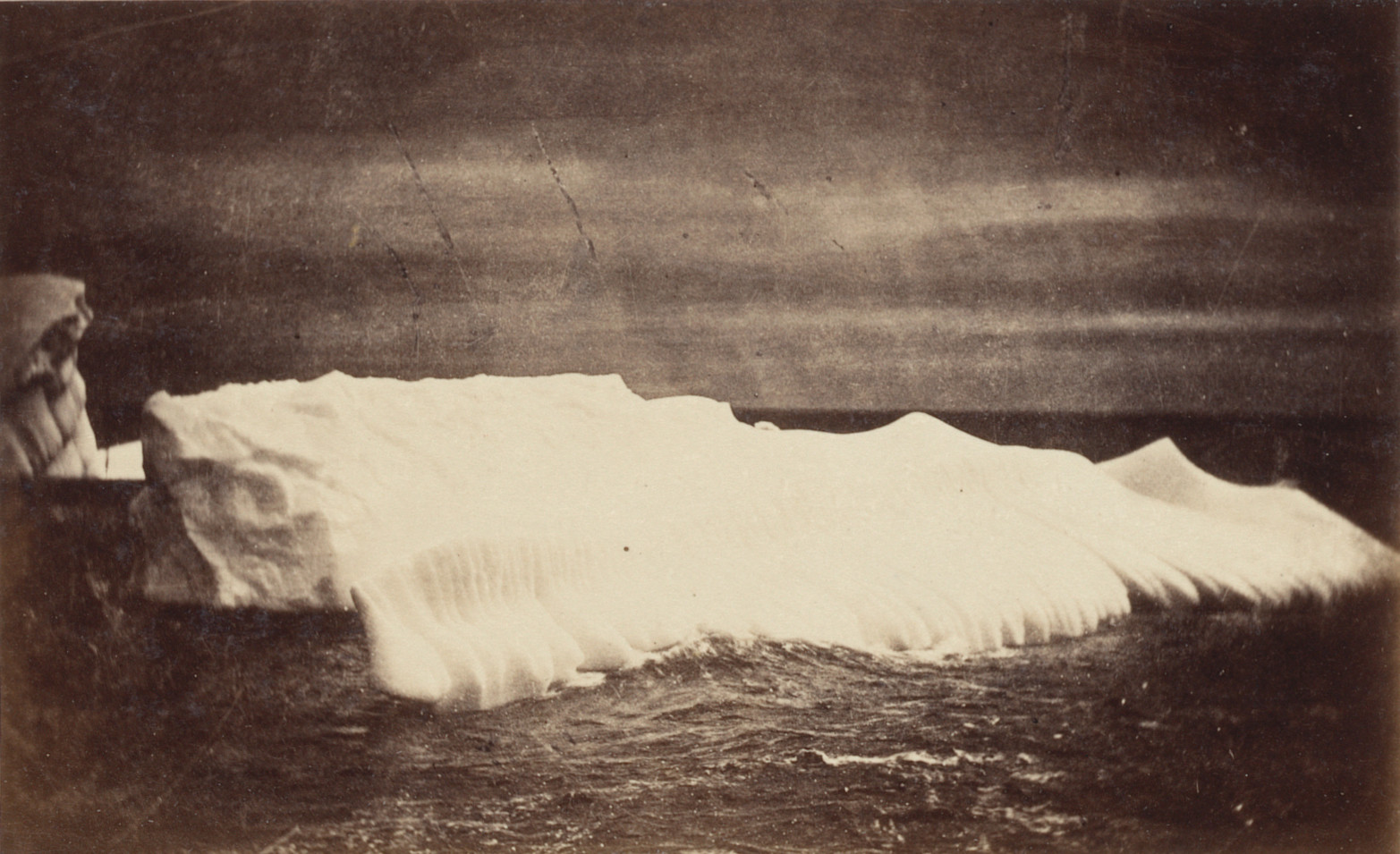 George P. Critcherson, John L. Dunmore, William Bradford. "Section of iceberg, which was broken off from the side, and washed in ridges as seen; the side of the berg for over 100 feet presented the same appearance.". 1869