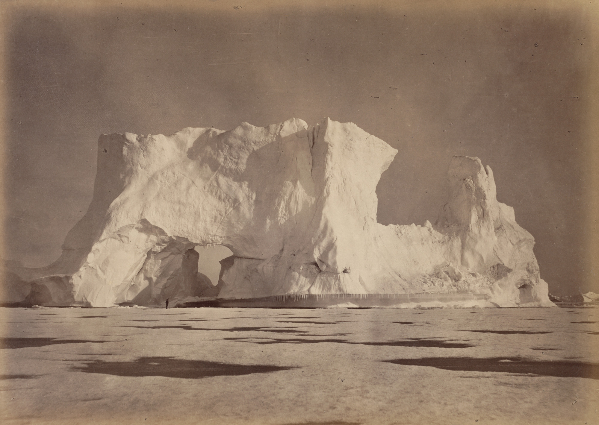 George P. Critcherson, John L. Dunmore, William Bradford. "Castle Berg in Melville Bay over two hundred feet high. The Figure, which is some seventy-five feet from the Base, gives an object to compare with the Berg. The Ice in the foreground is about eighteen inches in thickness.". 1869
