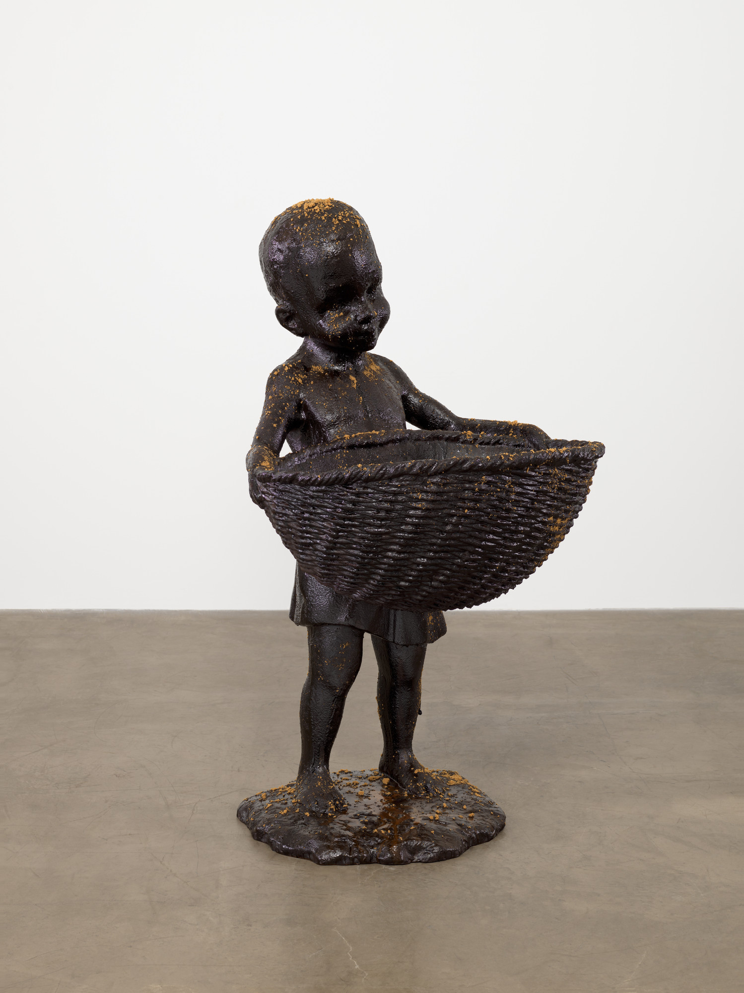 Kara Walker. African Boy Attendant Curio with Molasses and Brown Sugar, from "The Marvelous Sugar Baby" Installation at the old Domino Sugar Factory Warehouse (Front Basket)