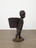 Kara Walker. African Boy Attendant Curio with Molasses and Brown Sugar, from "The Marvelous Sugar Baby" Installation at the old Domino Sugar Factory Warehouse. (Rear Basket),. 2014