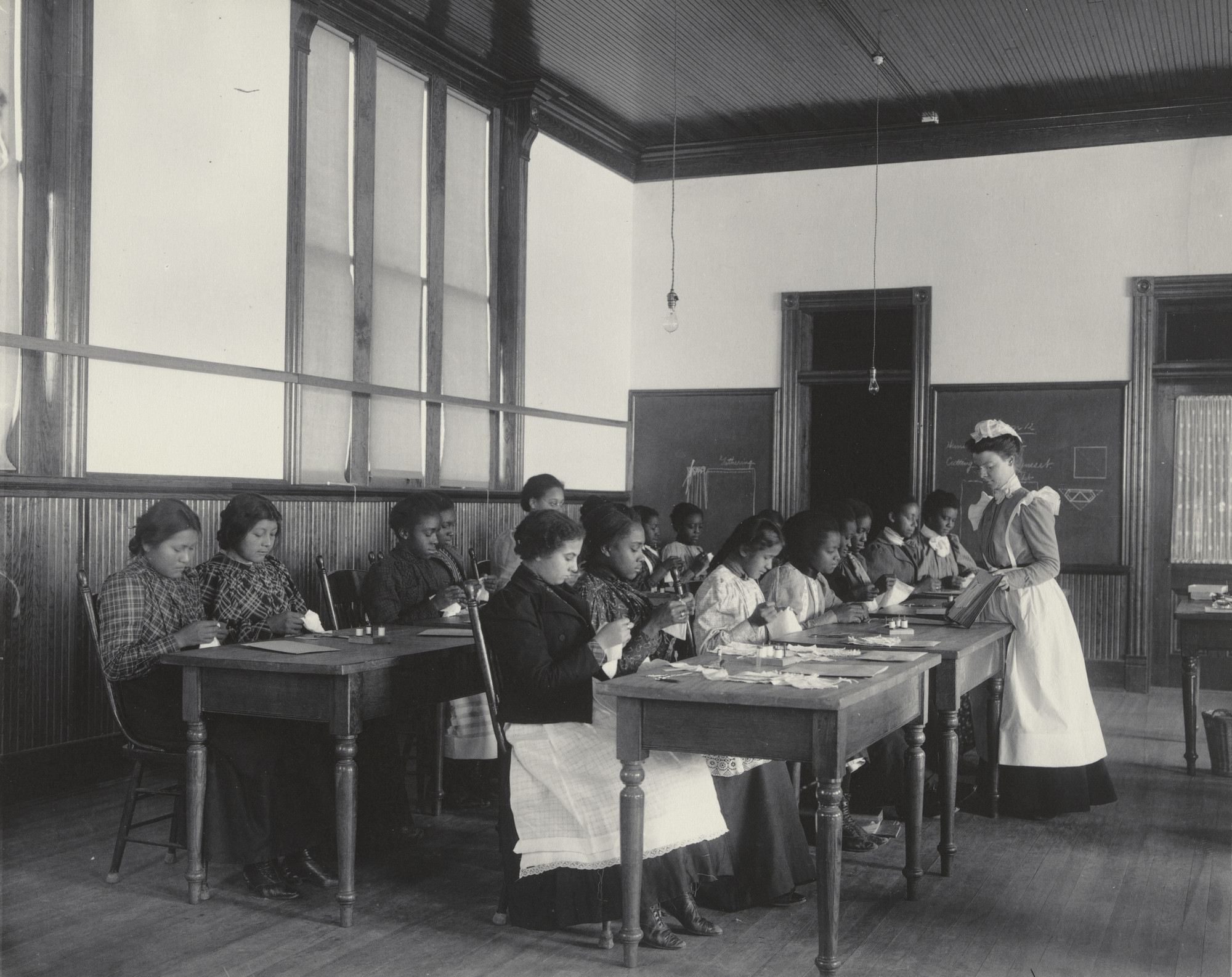 Frances Benjamin Johnston. A class in simple sewing