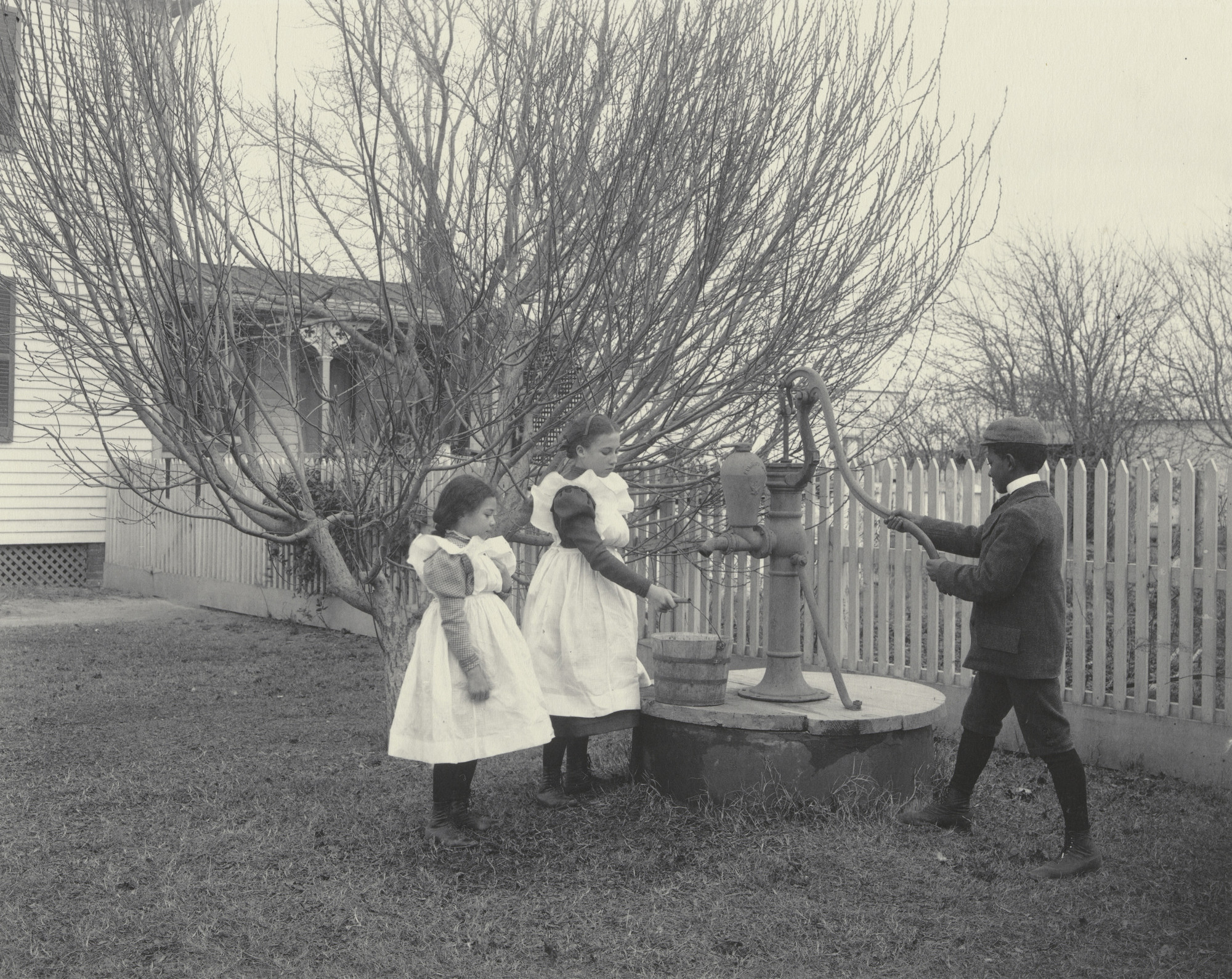 Frances Benjamin Johnston. The improved well. (Three Hampton grandchildren.)