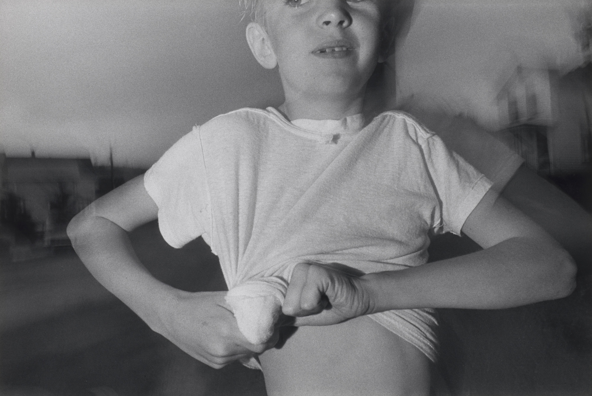 Mark Cohen. Boy Twisting Shirt
