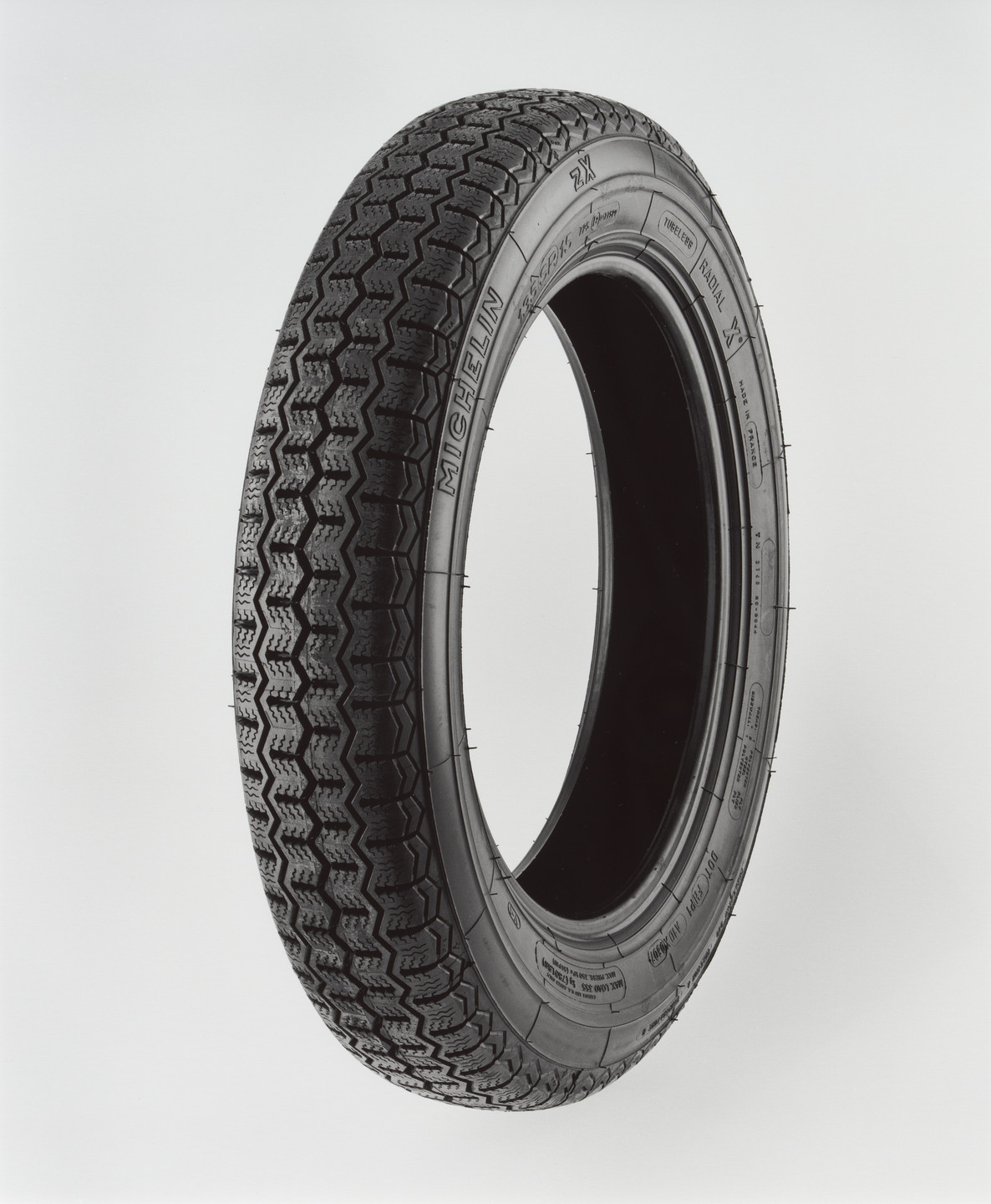 Christopher Williams. Clockwise from Manufacturer Name (Outer Ring), Michelin zX, Treadwear 200, Traction A, Temperature B, Clockwise from Tire Size (Inner Ring), 135 SR 15, 723 E2 0177523, Tubeless, Radial X, Made In France, TN 2148 20-2044, Tread: 1 Polyester Ply, + 2 Steel Plies, Sidewall: 1 Polyester Ply, DOT FH PI AID X0607, Canada and U.S. Codes Only, Max Load 355 Kg (780 Lbs), Max Press. 350 kPa (51 PSI), V-1, Photography by the Douglas M. Parker Studio, Glendale, California, December 27, 2007–January 2, 2008. 2008