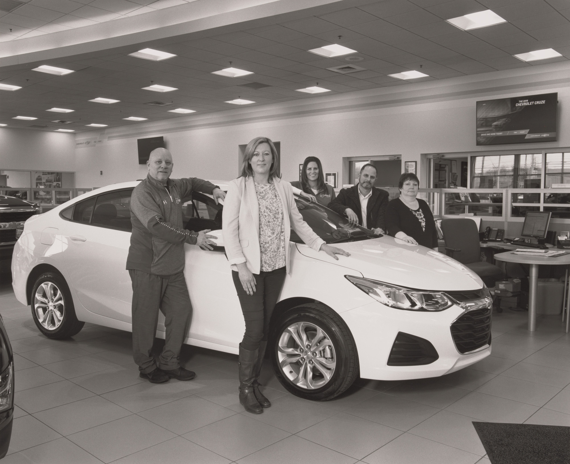 LaToya Ruby Frazier. Sweeney Chevrolet Buick GMC car dealership Vice President Alexa Sweeney Blackann with Sales and Leasing Specialist Keith Burke, Product Specialists Debra DePaul and Elie Khoury, and Service Cashier Lisa Cartwright, standing with the last Cruze, Board-man, OH
