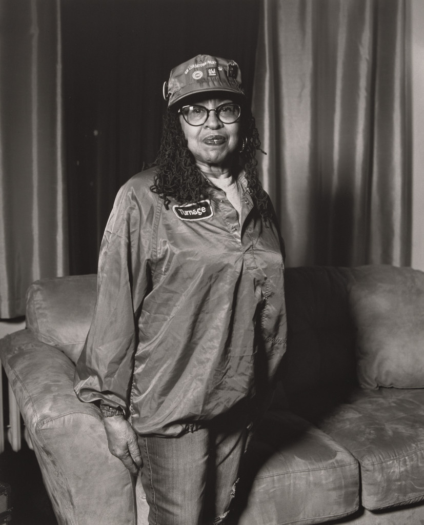 Frances Turnage, UAW Local 1112, Women’s Committee, standing in her living room, wearing her work uniform (34 years in at GM Lordstown Complex, paint shop), Youngstown, OH.
