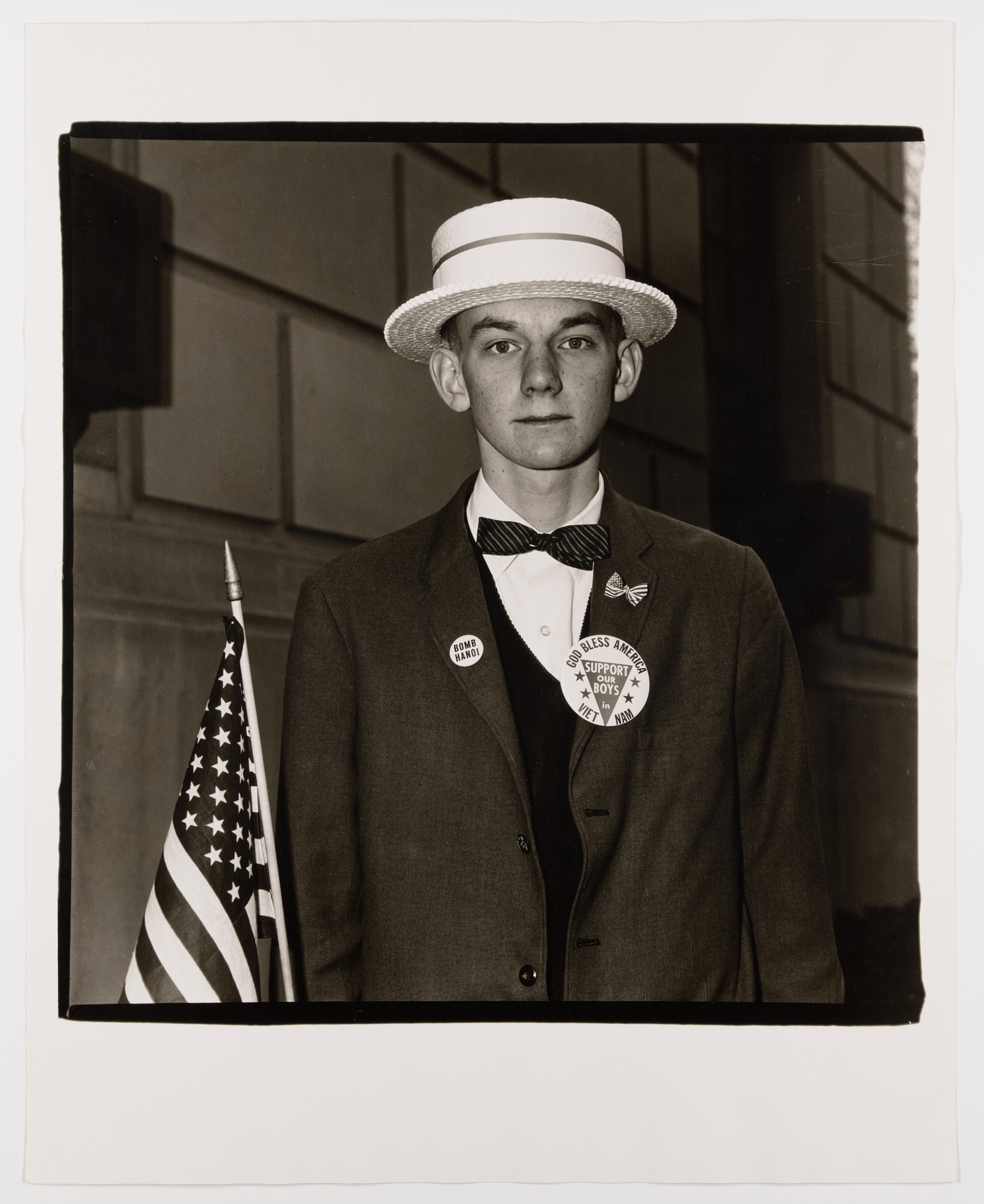 Diane Arbus. Boy with a straw hat waiting to march in a pro-war parade, N.Y.C., 1967