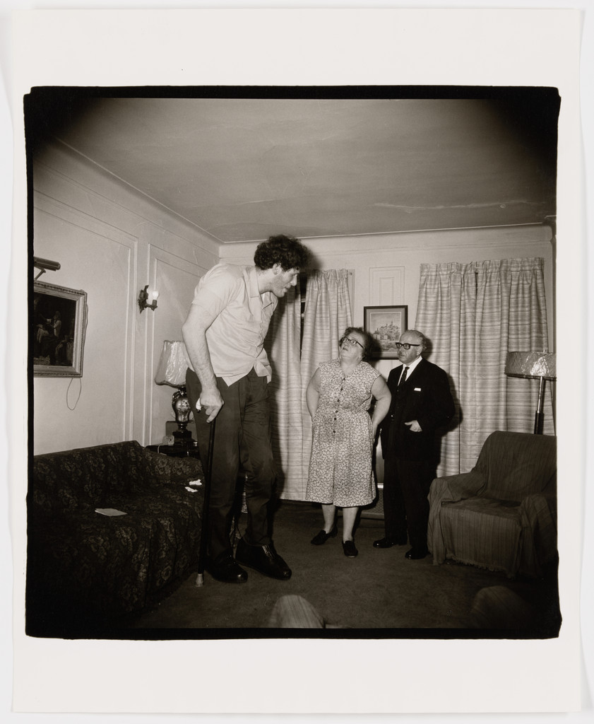 A Jewish giant at home with his parents in the Bronx, N.Y., 1970